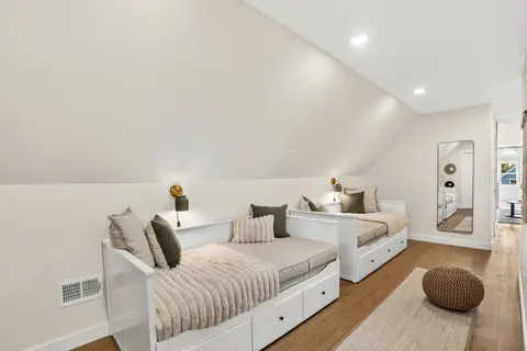 Bright third-floor sleeping space with two daybeds and linens