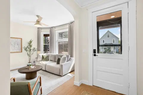 Front living room with a sofa and bay windows