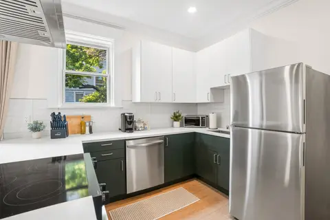 Kitchen with stainless appliances, counter space, and a sunny window