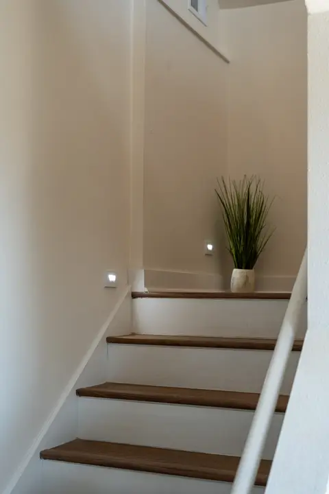 Illuminated staircase leading to the third floor