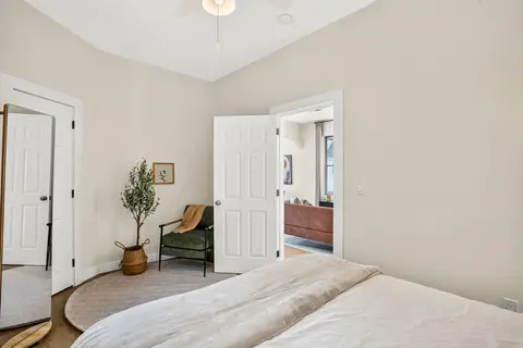 Bright queen bedroom with a sitting area