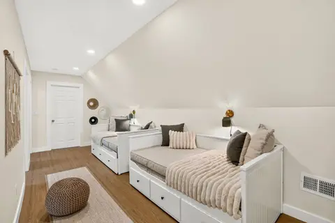 Third-floor sleeping area with two daybeds and built-in storage