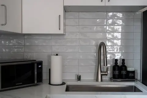Kitchen sink area stocked with hand soap, dish soap, and everyday essentials