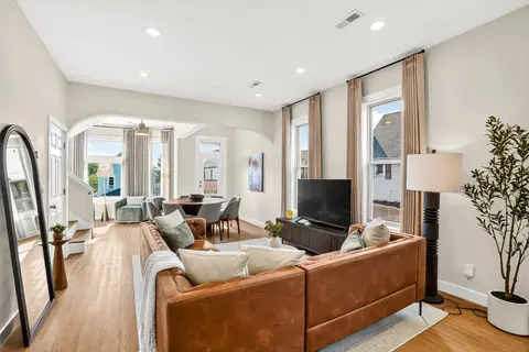 Open living and dining space with leather seating and large windows