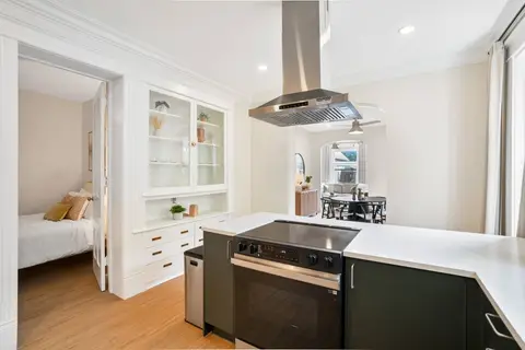 Open kitchen with counter space and views into the adjoining dining and bedroom areas