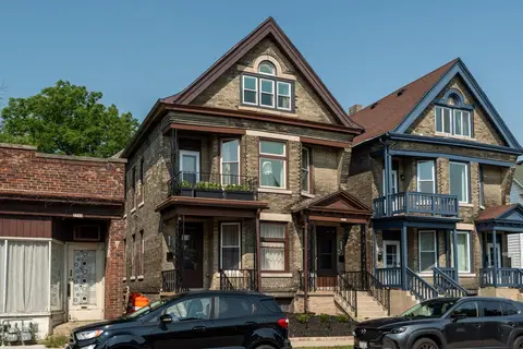 Wide exterior view of the home and neighboring historic residences in Bay View
