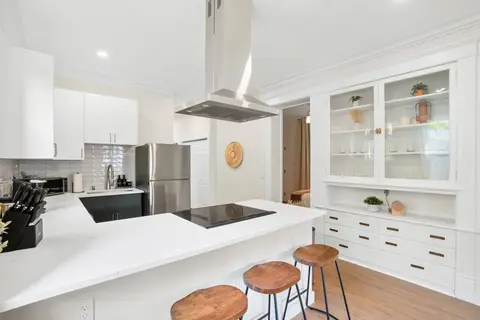 Bright kitchen with island seating and built-in cabinetry