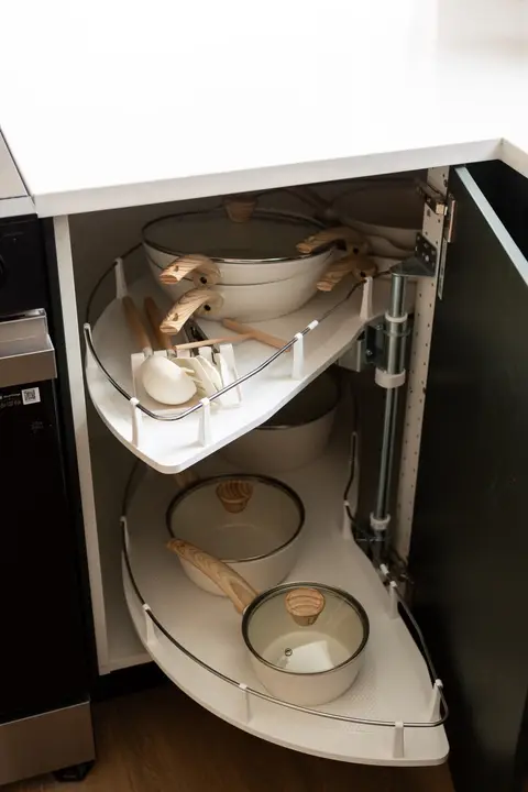 Kitchen stocked with cookware, lids, and serving utensils