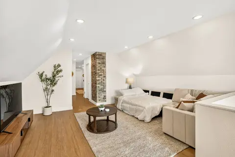Upper-level lounge with sectional seating and an additional sleeping area