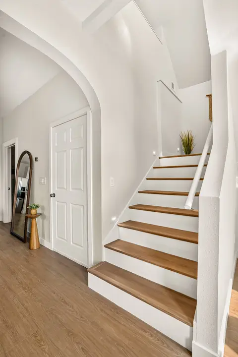 Bright interior staircase connecting the home’s updated upper levels