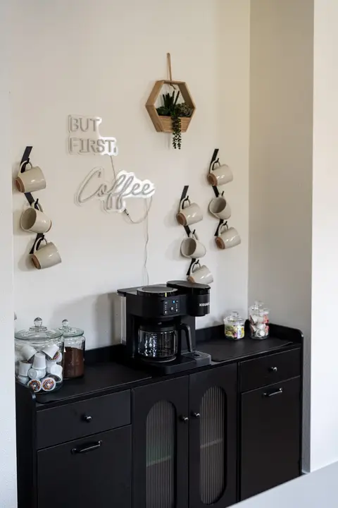 Coffee bar stocked with mugs and supplies