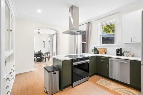 Bright, fully equipped kitchen with an open view toward the dining room