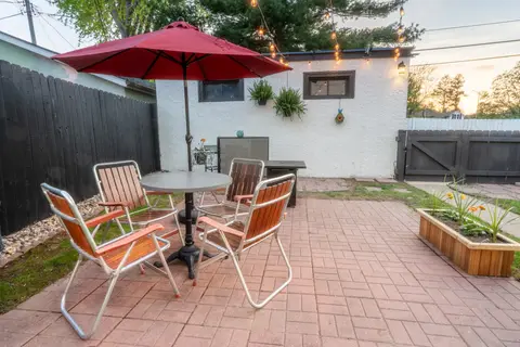 Shared patio with raised planters, under the string lights