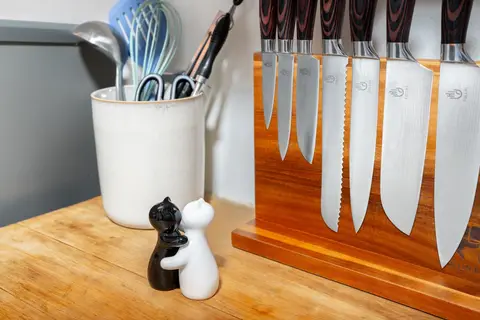 Full knife block and utensils on the butcher block