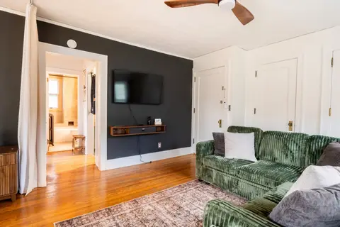 Living room TV wall and sectional, looking through to the bathroom
