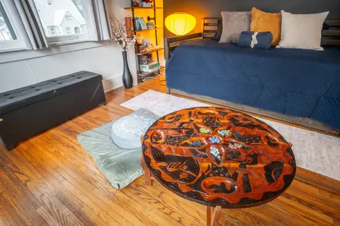 Trundle daybed and the hand-carved table in morning light