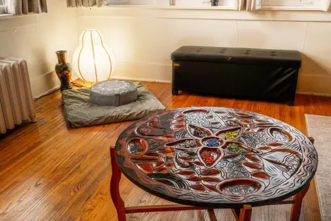 Floor cushion and paper lantern by the radiator