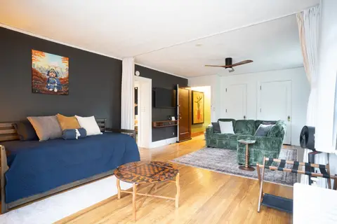 Living room looking toward the entry, with the trundle daybed on the left
