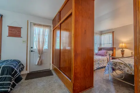 Twin beds on either side of a tall wood wardrobe