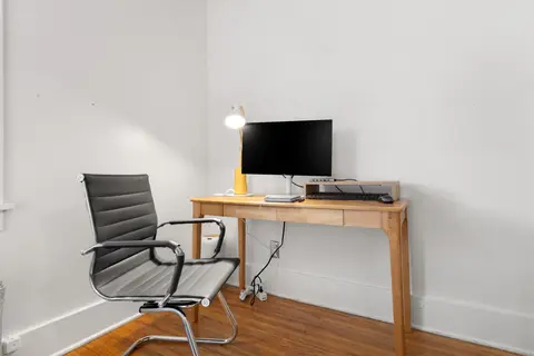 Workstation with a 47-inch solid wood desk, a 27-inch monitor, a USB-C dock, and an office chair