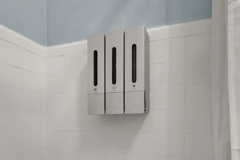 Shower dispensers with refillable shampoo, conditioner, and body wash
