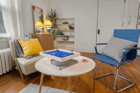 KLASK on the coffee table, with the reading chair and built-in shelves