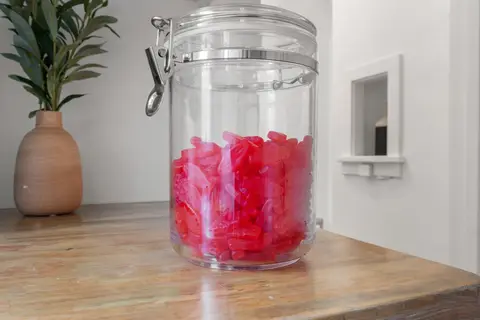A jar of Swedish Fish on the kitchen hutch