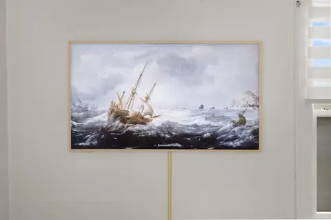Bedroom TV in art mode, showing a painting of a ship at sea