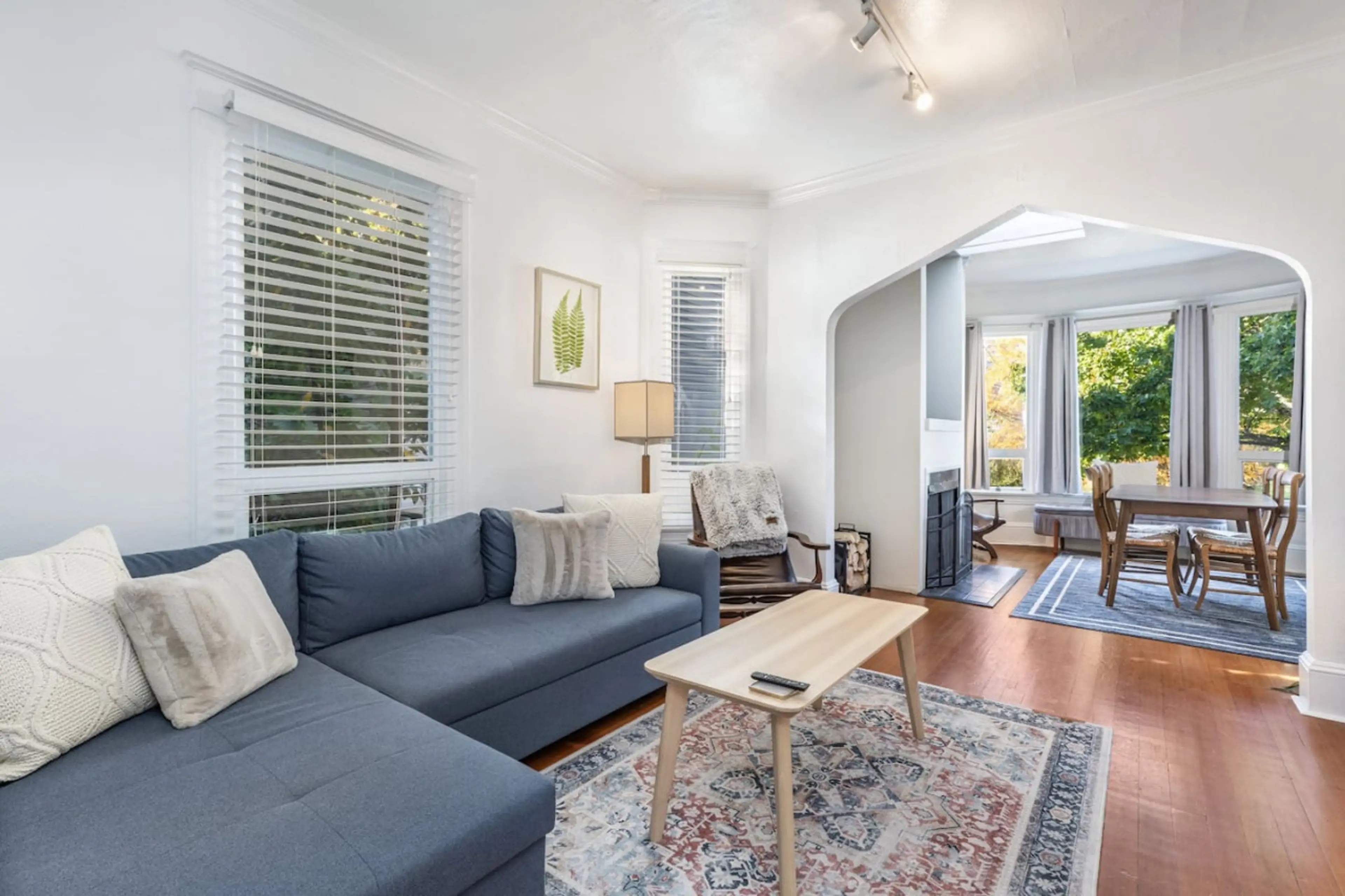 Spacious living room leading to the dining area, ideal for gatherings and meal times.