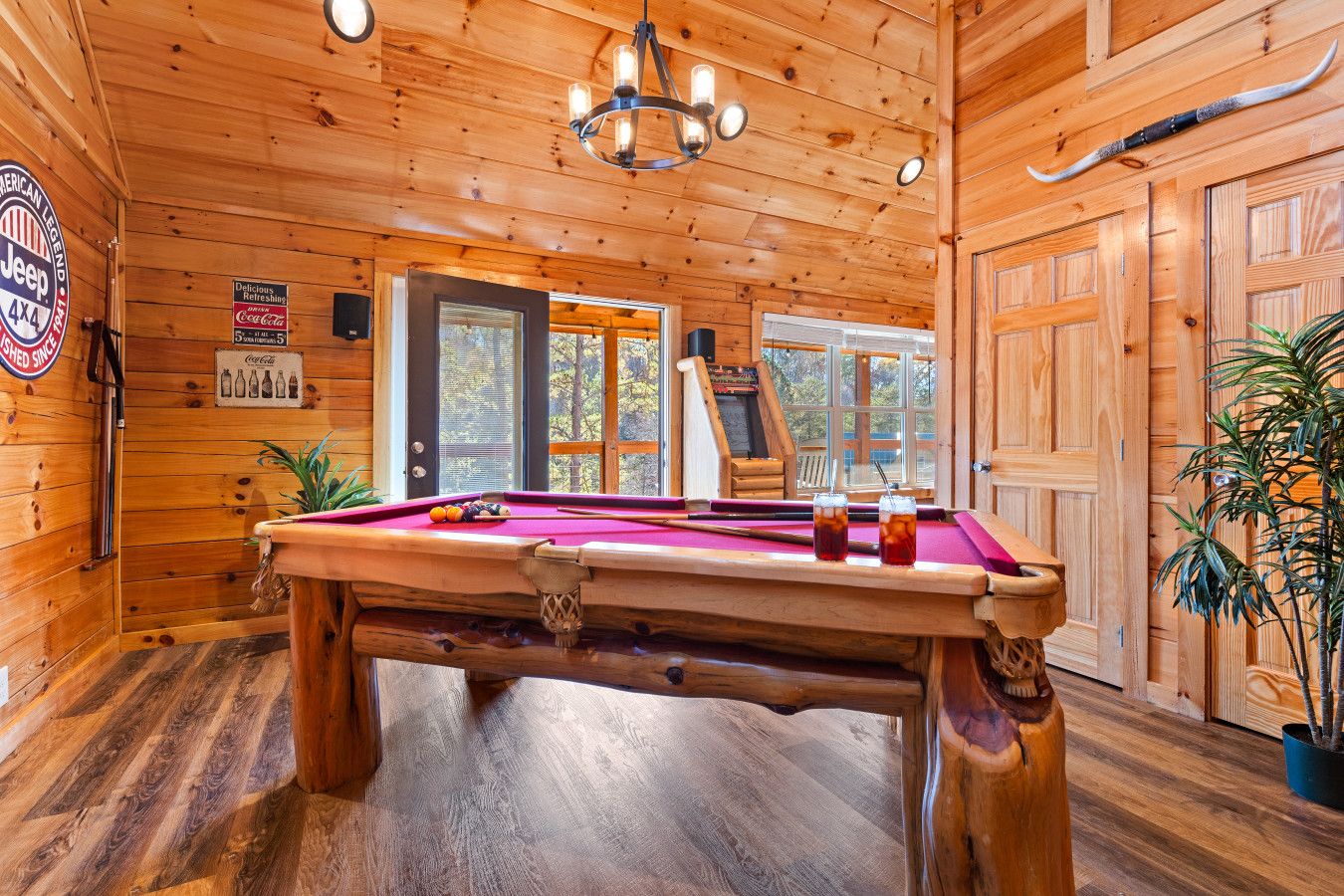 Enjoy endless entertainment with a game room featuring a pool table, arcade games, and a private movie theater just steps from the living room.