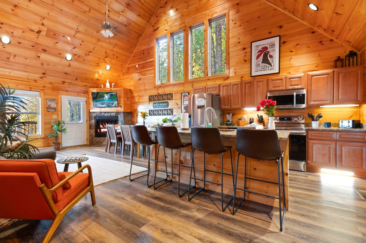 Experience a spacious living room with floor-to-ceiling windows, inviting natural light and stunning mountain views for unforgettable moments.