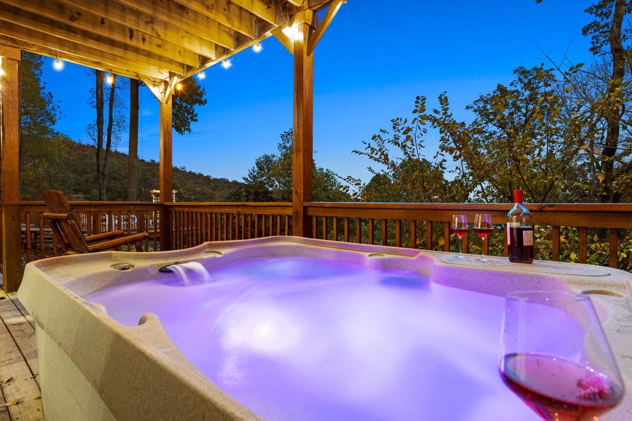 Enjoy the private hot tub in this cabin, drink in hand, as you take in the sunset views.
