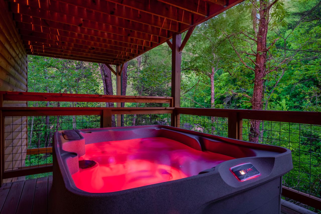 Relax in the hot tub with a partial wooded view.