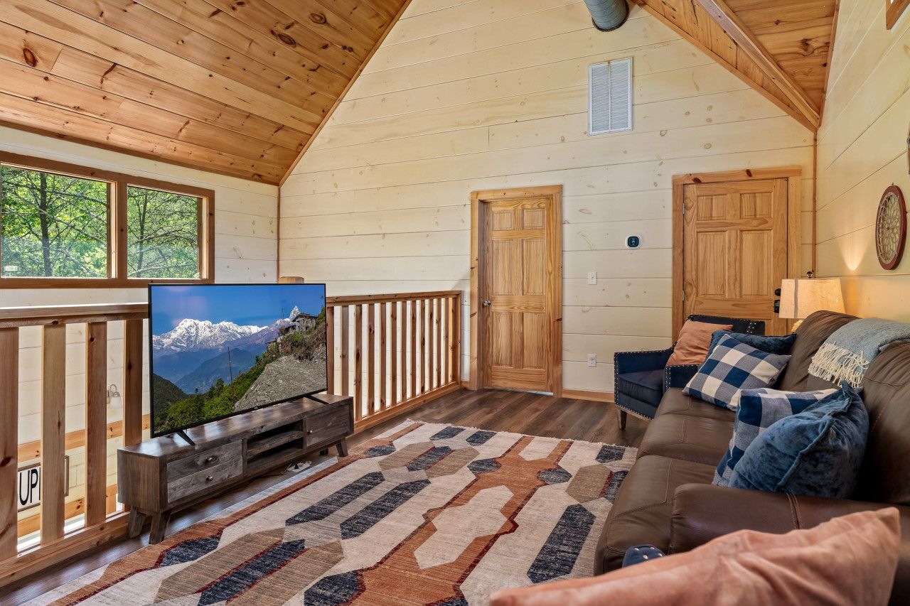 Unwind in a bright and spacious living room with comfortable seating, large TV, and fast Wi-Fi for effortless entertainment.