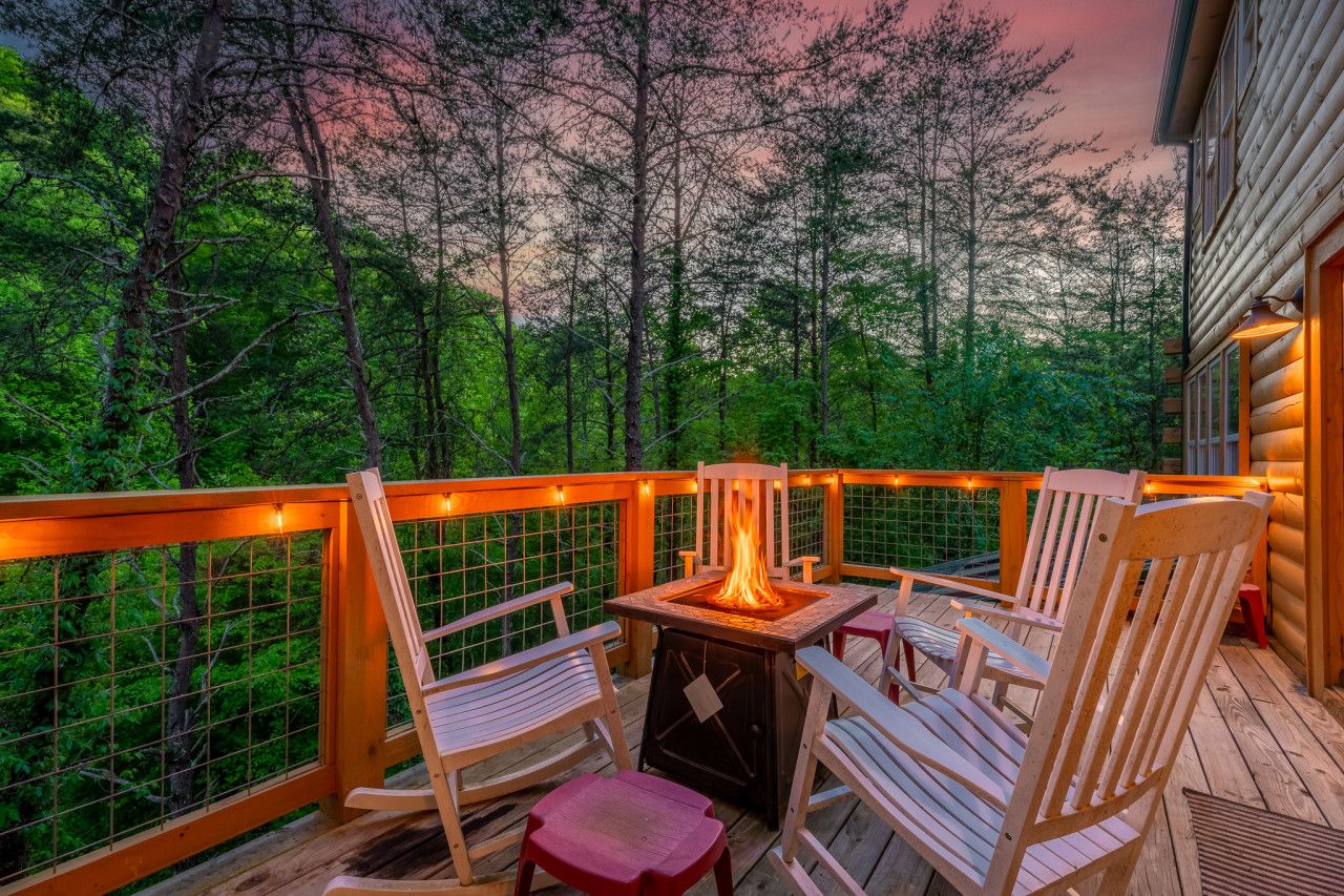 Escape to this cabin, where evenings by the deck fire overlook a quiet, wooded setting.