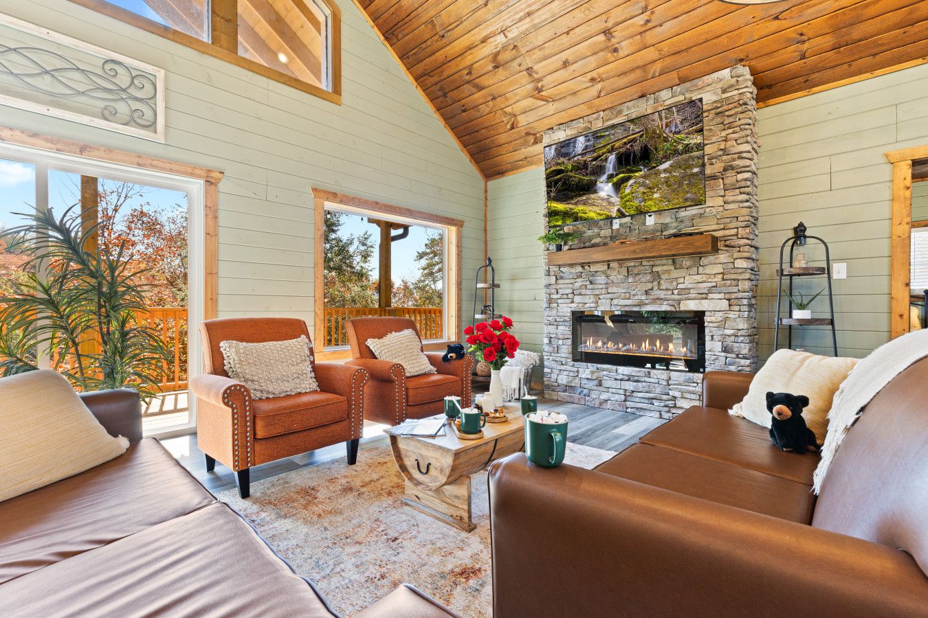 This cabin features a generous living room opening onto scenic decks—perfect for relaxing, playing, and soaking in stunning mountain views.