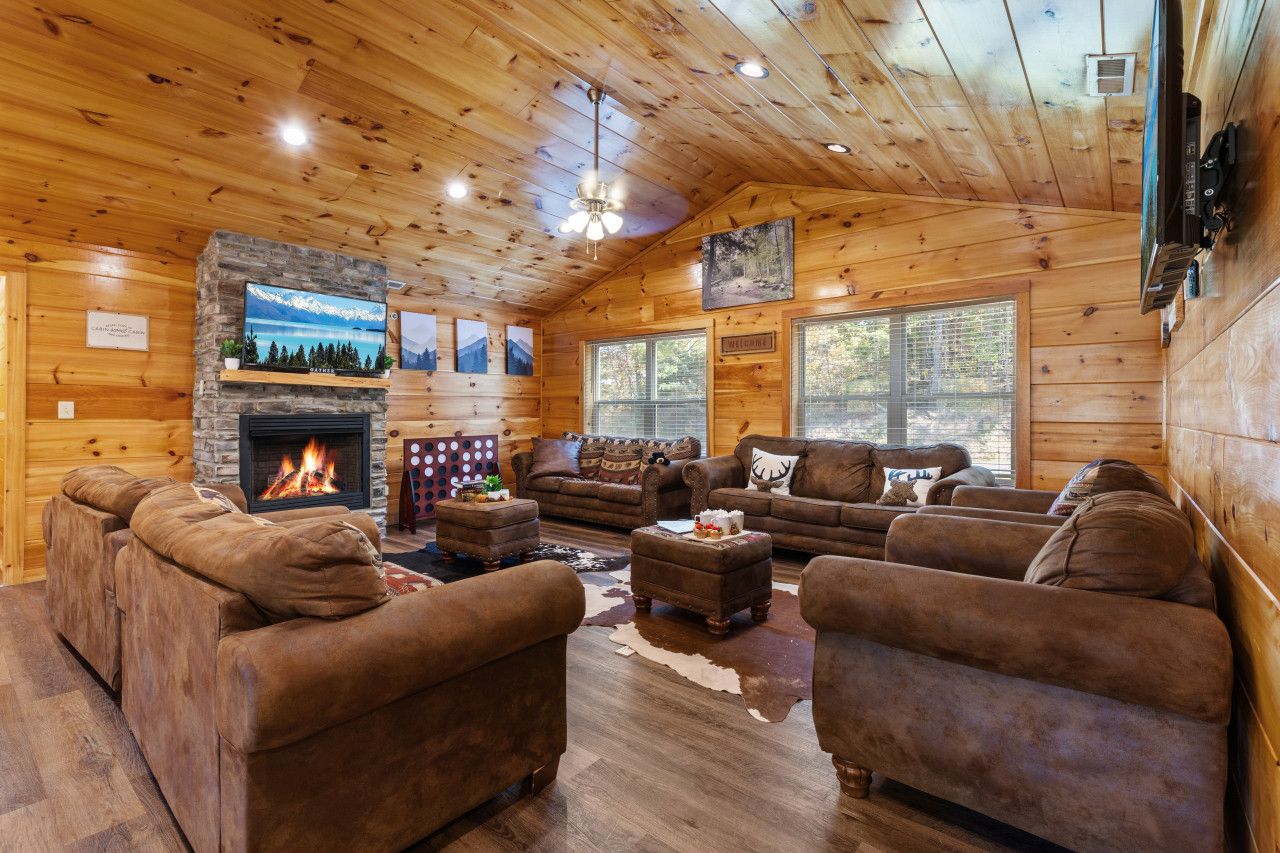 Cozy up in this spacious common room featuring two TVs, a fireplace, and stunning mountain views—a perfect space for movie nights, game days, or simply relaxing together.