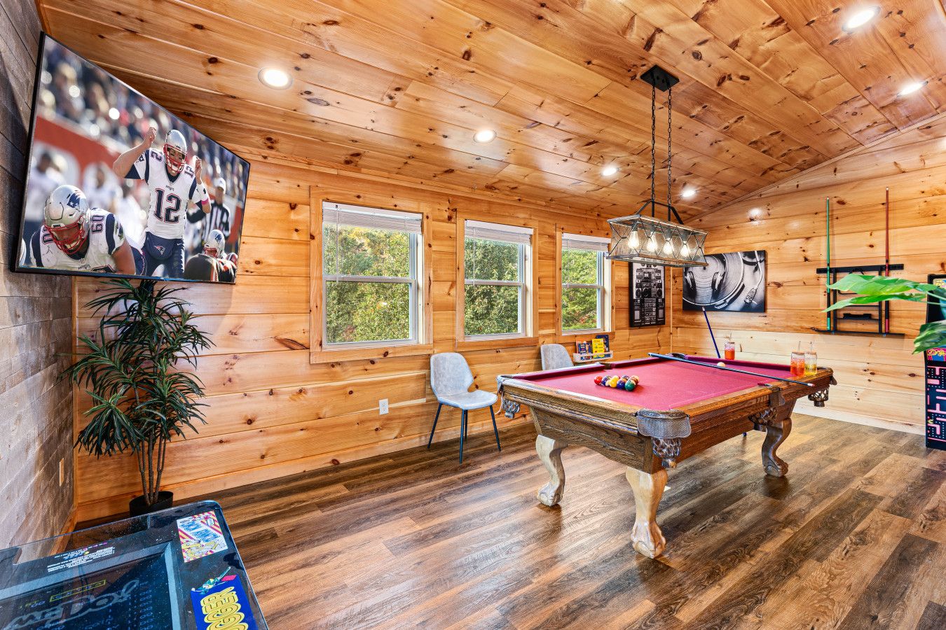 Experience this cabin’s ultimate game room—billiards, arcade fun, and the big game on screen.