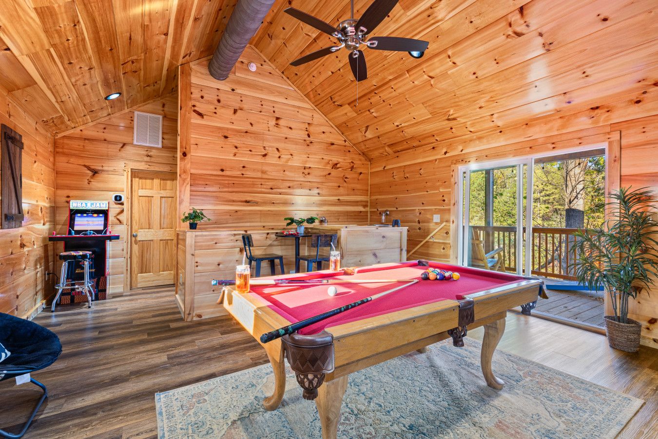 Escape to this cabin’s game room—play, relax, and take in panoramic mountain views while enjoying pool or arcade games.