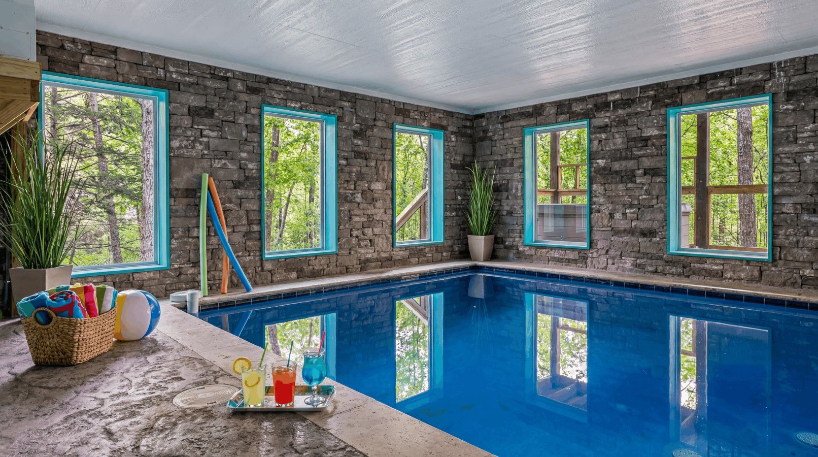 Spacious indoor pool with stunning forest views and direct balcony access to the hot tub.