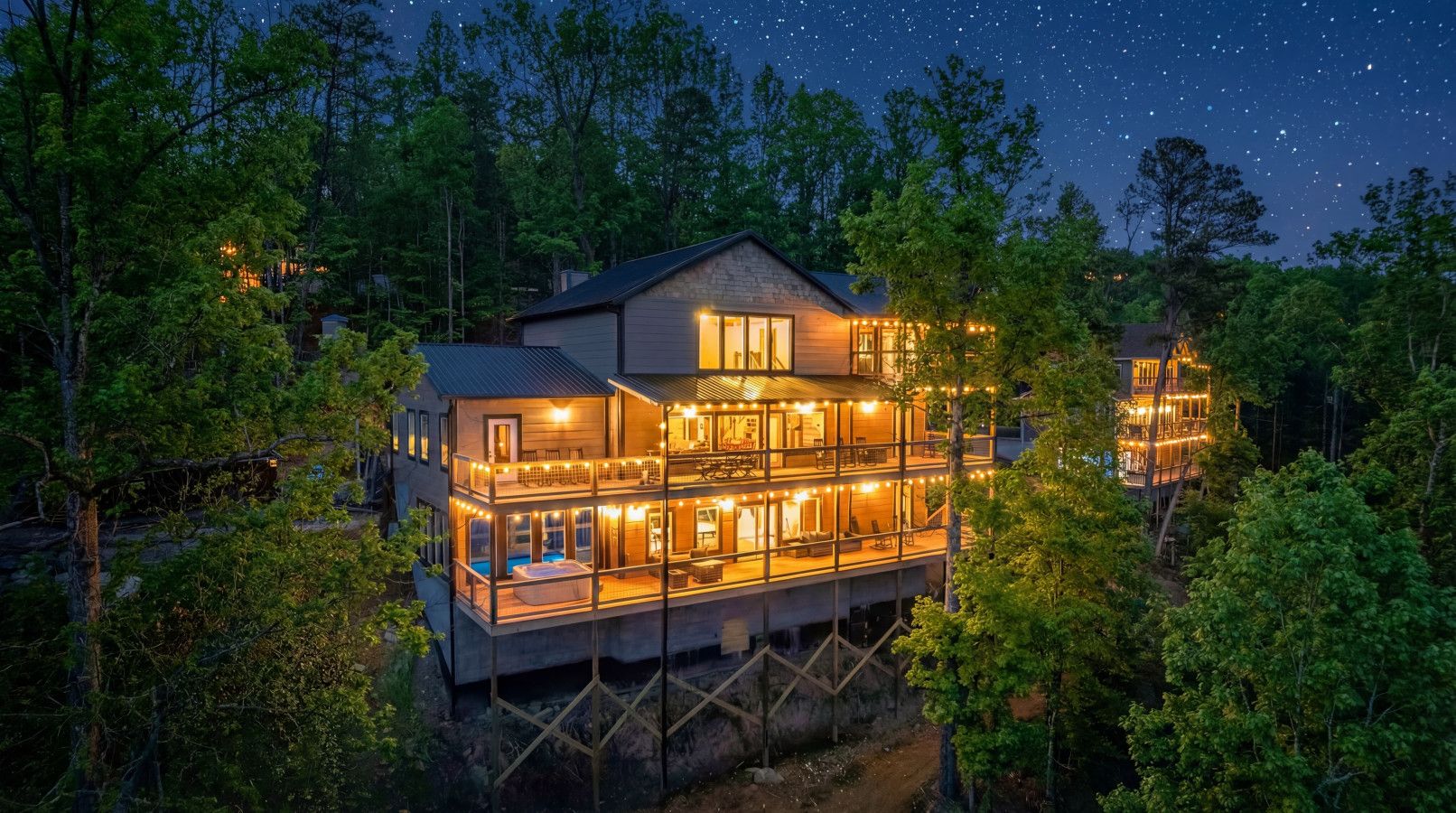 The Summit Collection glowing beneath the Smoky Mountain sky — the perfect setting for unforgettable nights together.