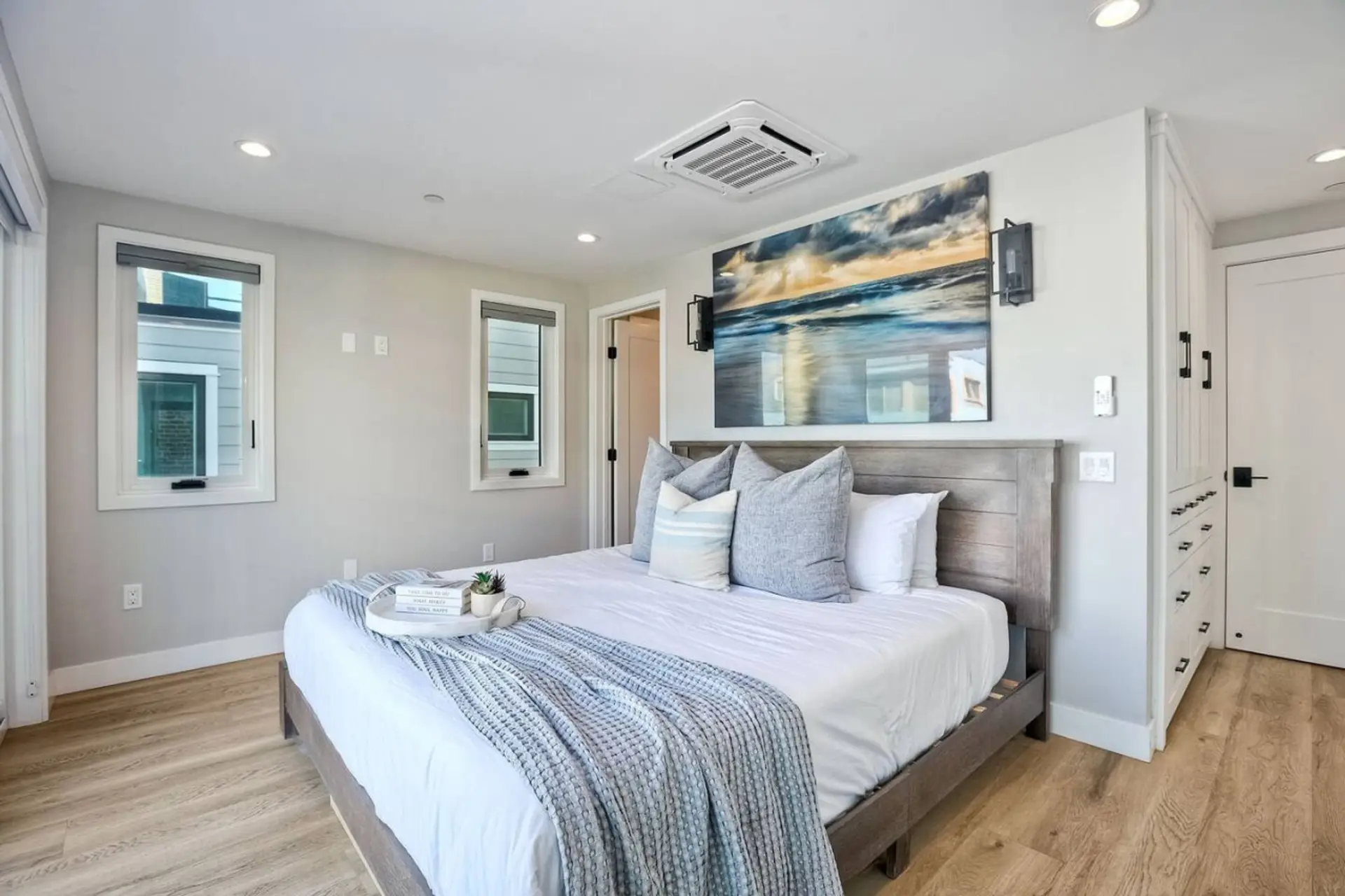 BEDROOM #3 PRIMARY BEDROOM Spacious primary bedroom with individual climate control and double sliding doors that bring in natural light and coastal breezes, creating a relaxing retreat during your Mission Beach San Diego vacation stay.