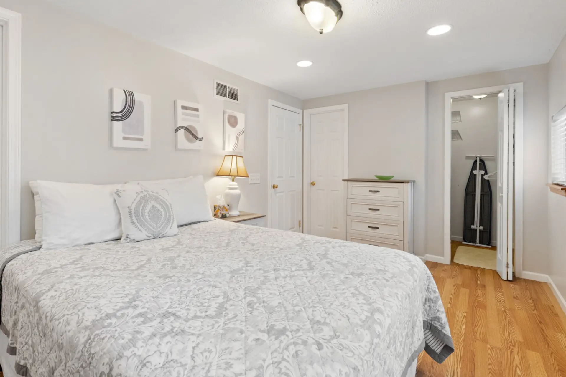 Main floor bedroom with plenty of clothing storage- walk-in closet an dresser