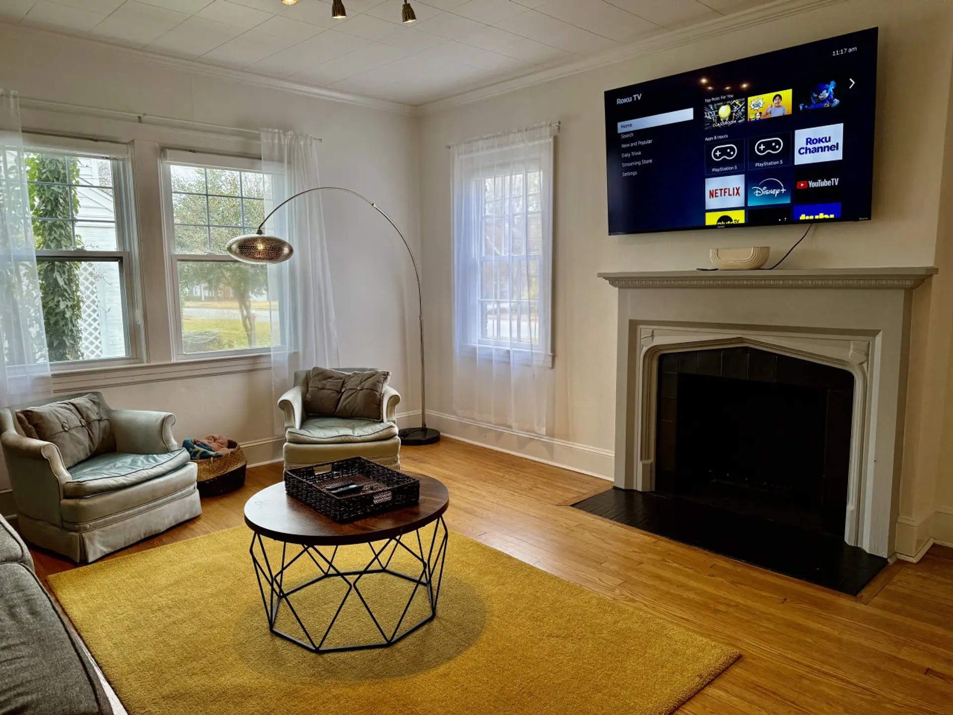 Fireplace in living room with large smart tv by our front entrance.