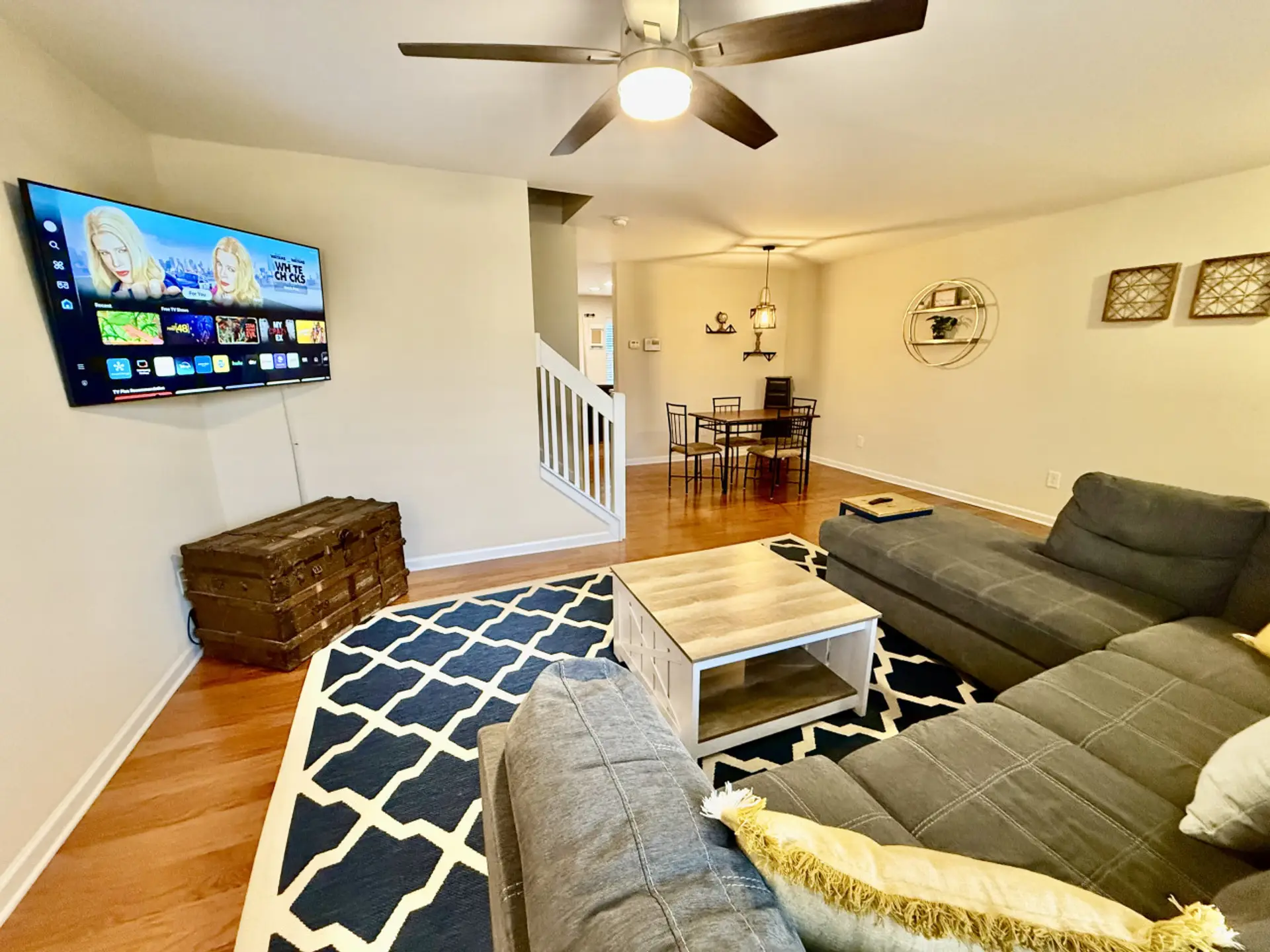 Cozy and stylish living room featuring a large sectional sofa, smart TV, and modern decor. Perfect for relaxing after a long day!