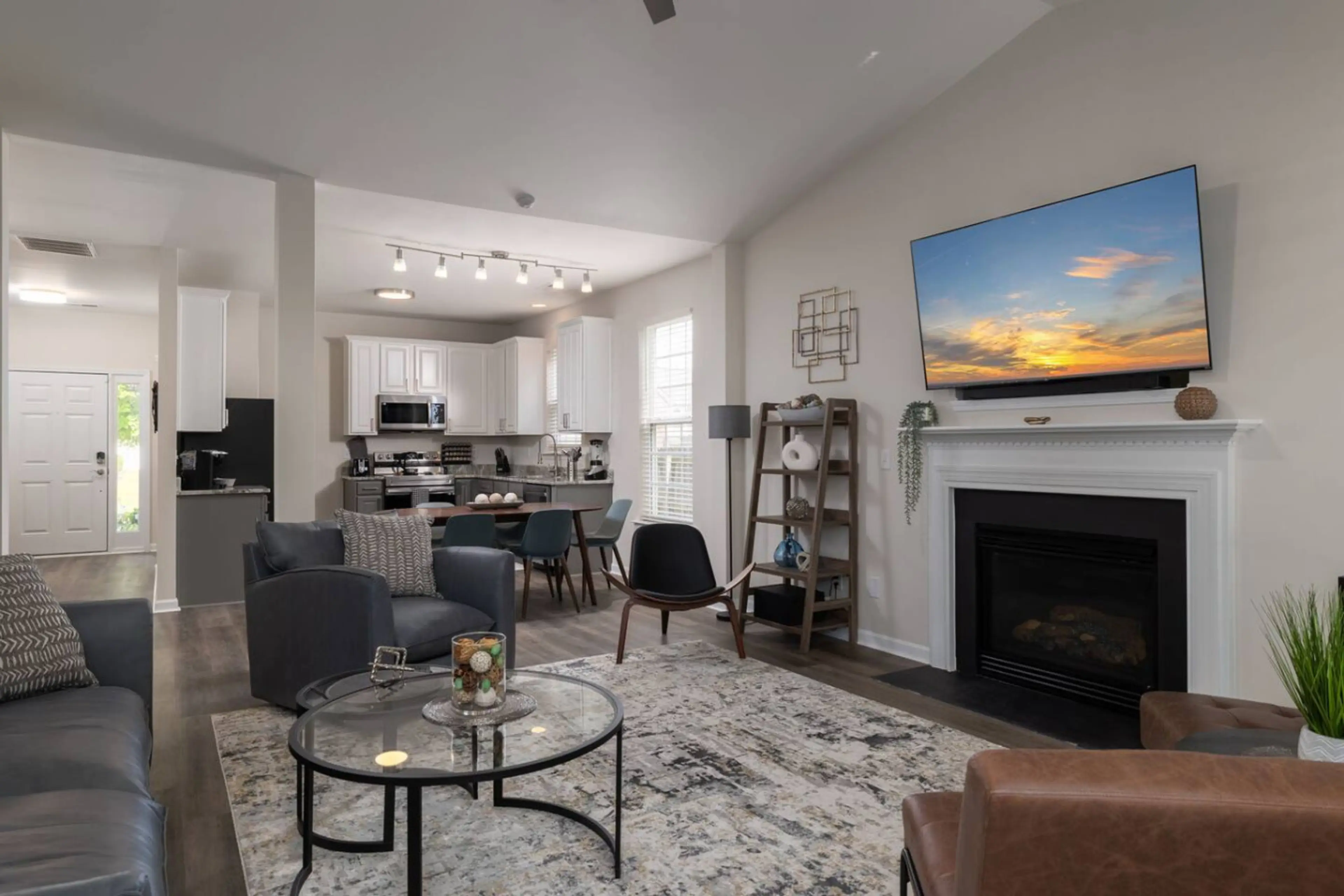 Large living room with multiple seating areas and a smart TV.
