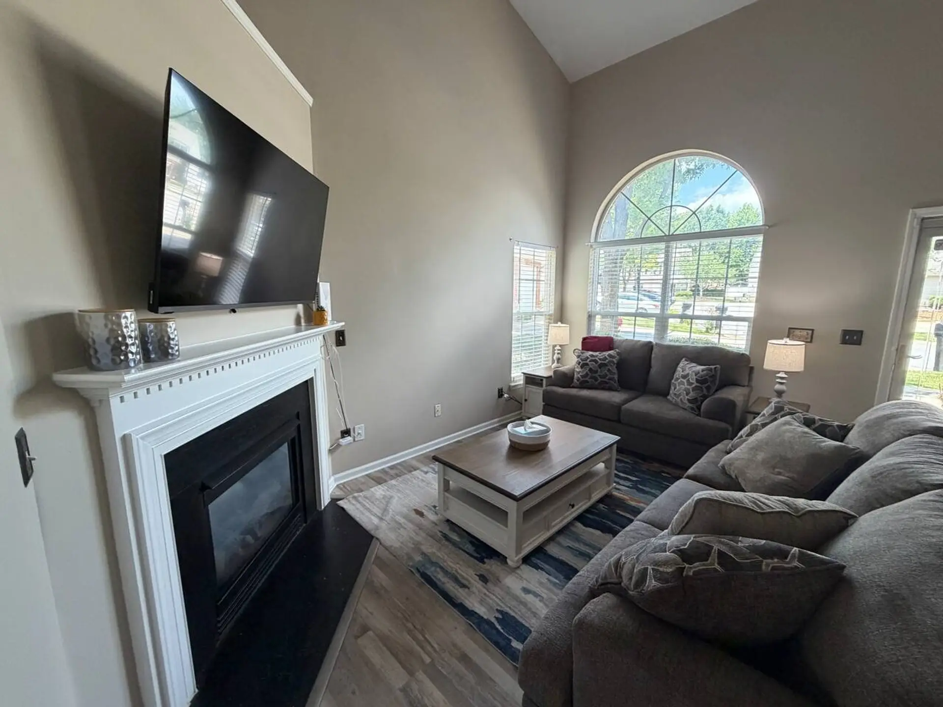 Living room with so much natural light and vaulted ceilings.