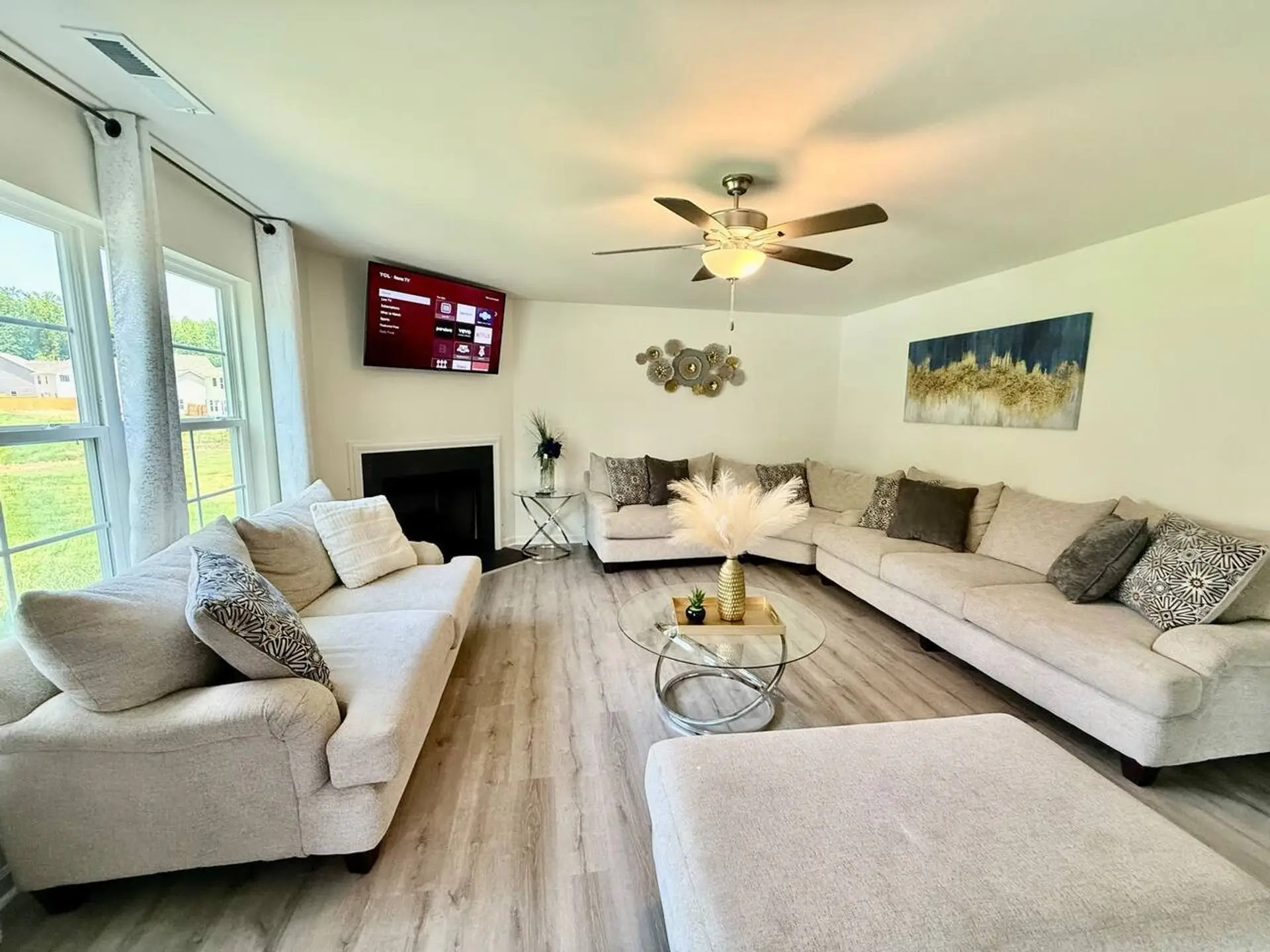 Large living room with multiple seating and smart tv