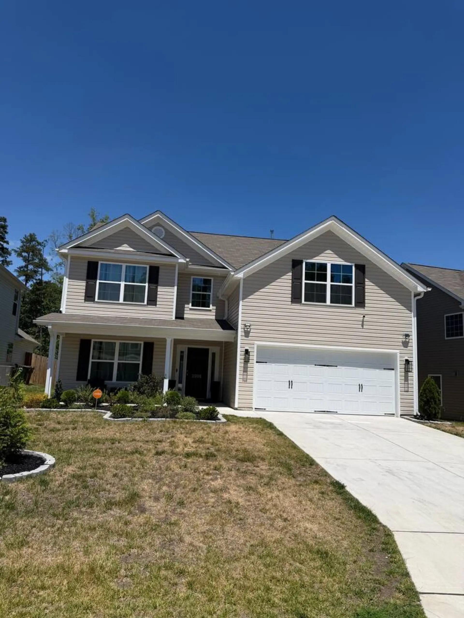 Large house with covered front porch.