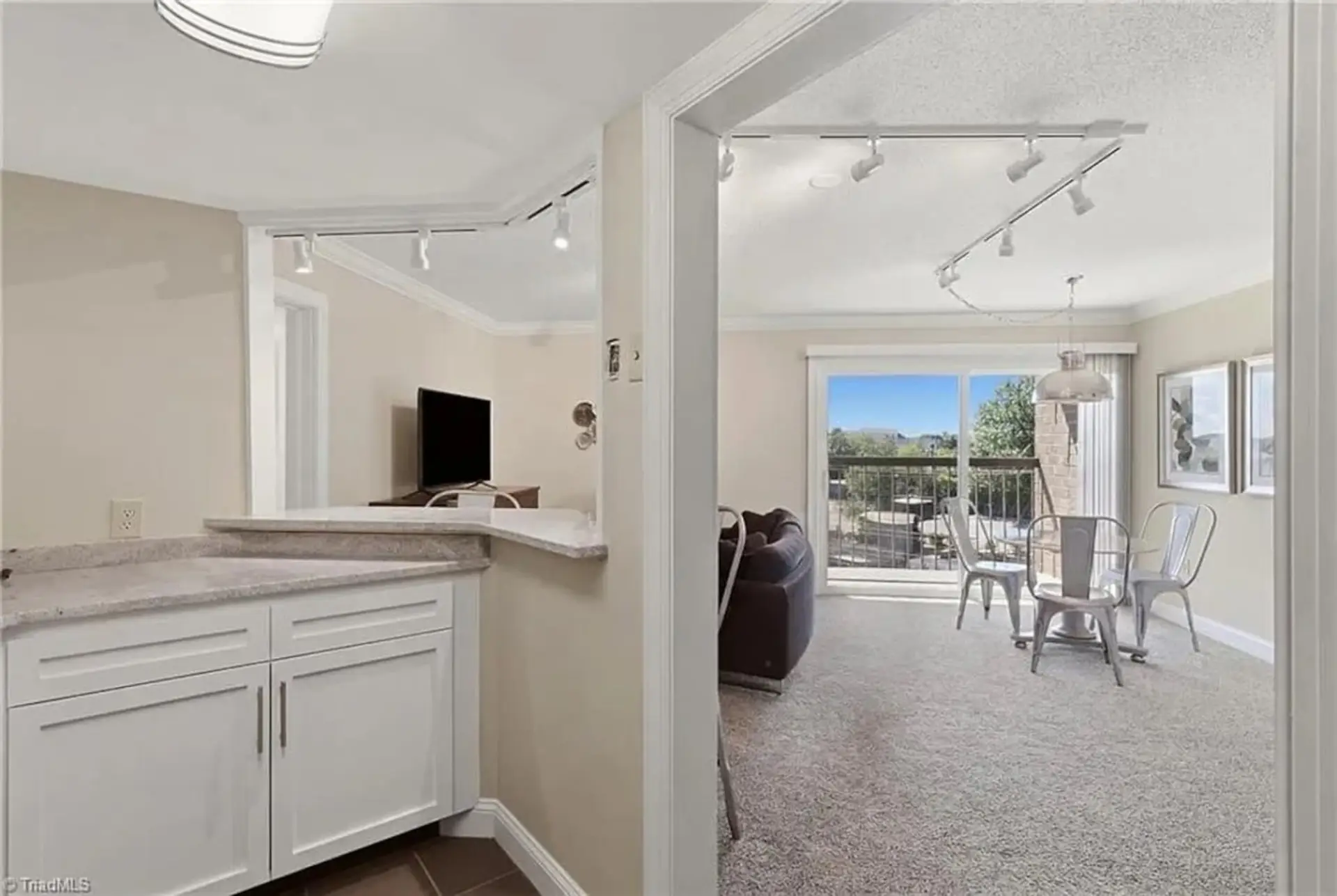 View from the kitchen. Comfortable living room with plenty of seating and smart TV